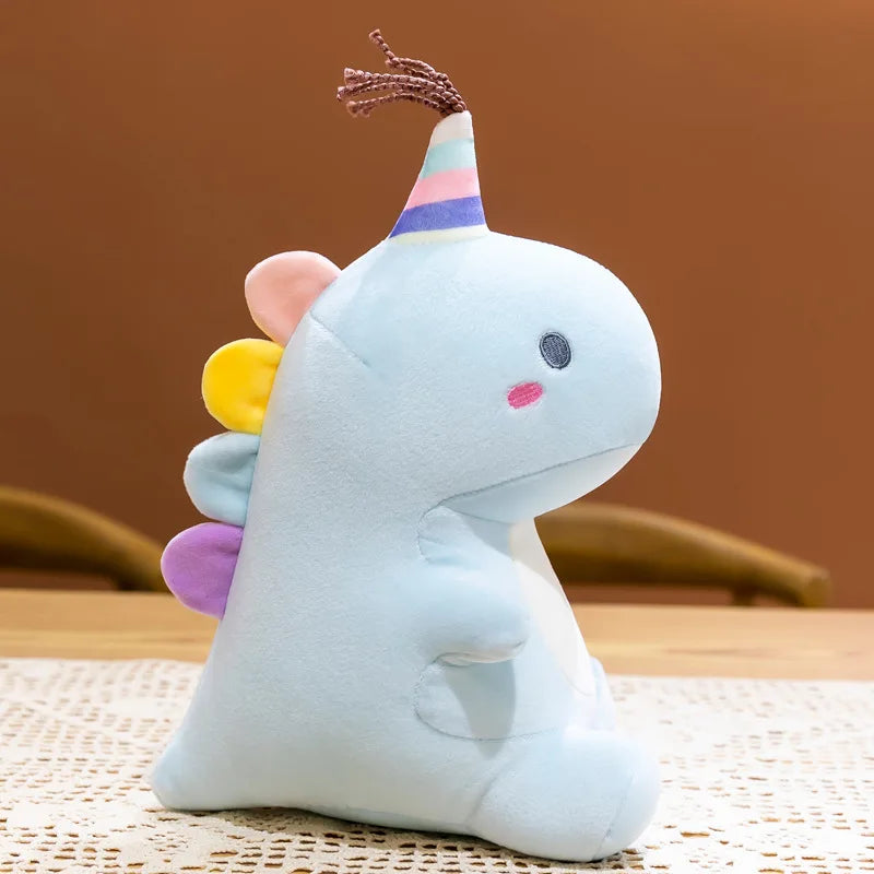 peluche dinosaure licorne bleue avec pompons et crête multicolore