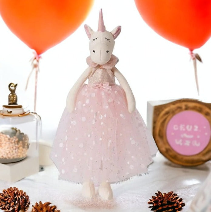 doudou peluche licorne fée en robe à rond brillant avec ceinture de satin rose avec noeud, haud côtelé rose avec fourrure rose en col