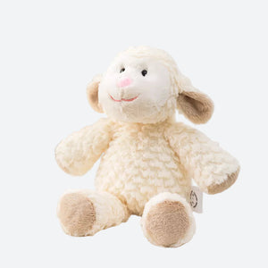 peluche mouton crème posé sur le canapé tissu crème