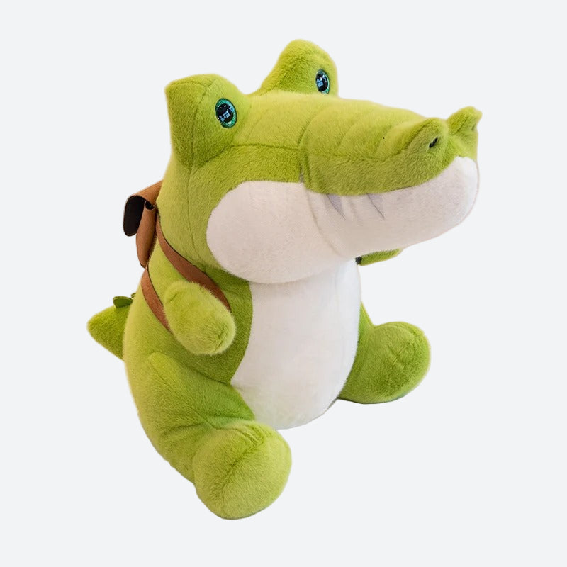 Peluche crocodile à sac à dos sur fond gris
