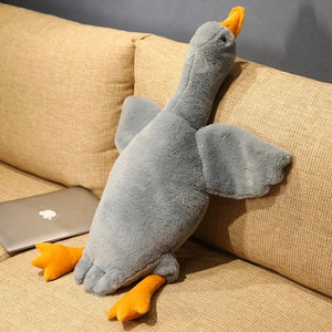 Peluche oie kawaii grise sur un canapé