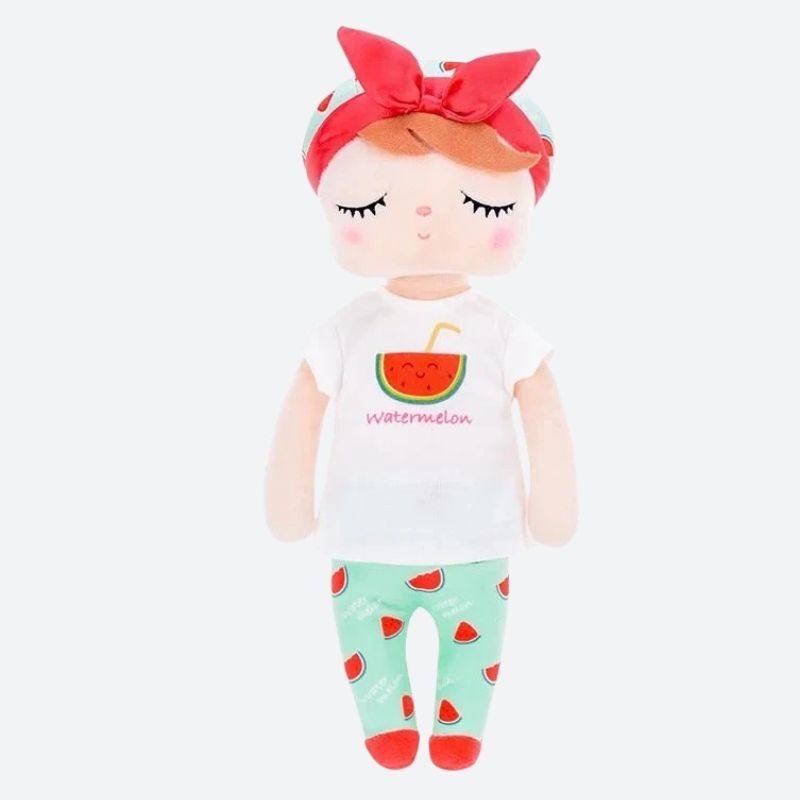 MASHA, la fée dolls de 34 cm, émerveille avec son t-shirt blanc orné d'un morceau de pastèque, son pantalon et son bonnet bleu ciel parsemés de morceaux de pastèque. Son bandeau à gros nœud et ses ballerines rouges ajoutent une touche de magie à son allure.