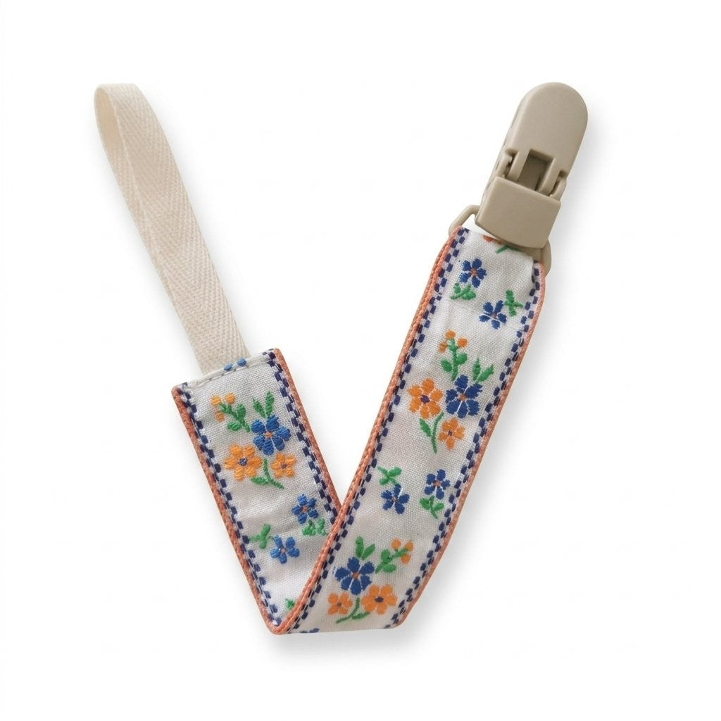 Attache tétine ruban brodé fleurs bleues