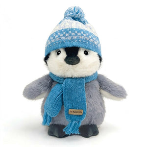 Peluche pingouin au bonnet et à l'écharpe tricotés bleus
