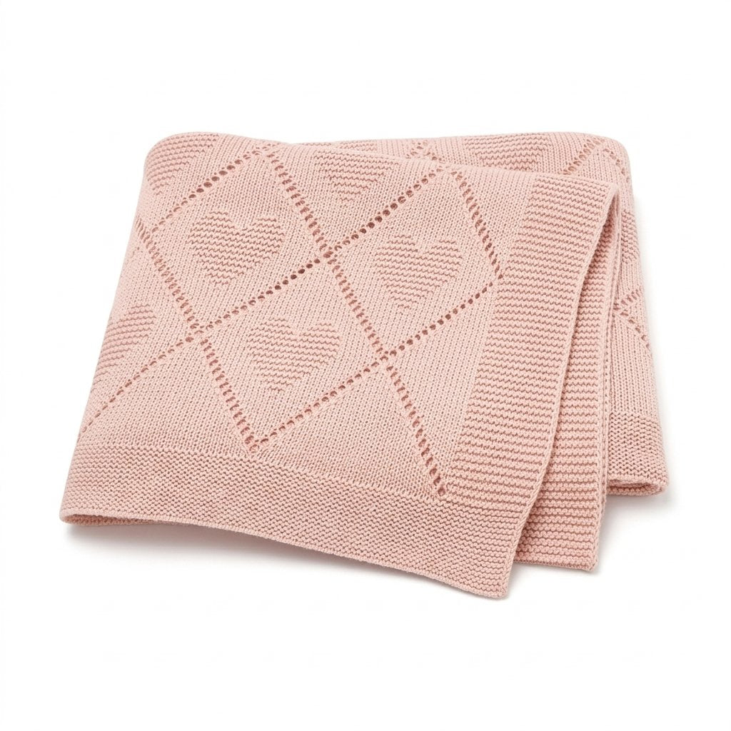 Couverture bébé en tricot de coton ajouré rose poudré